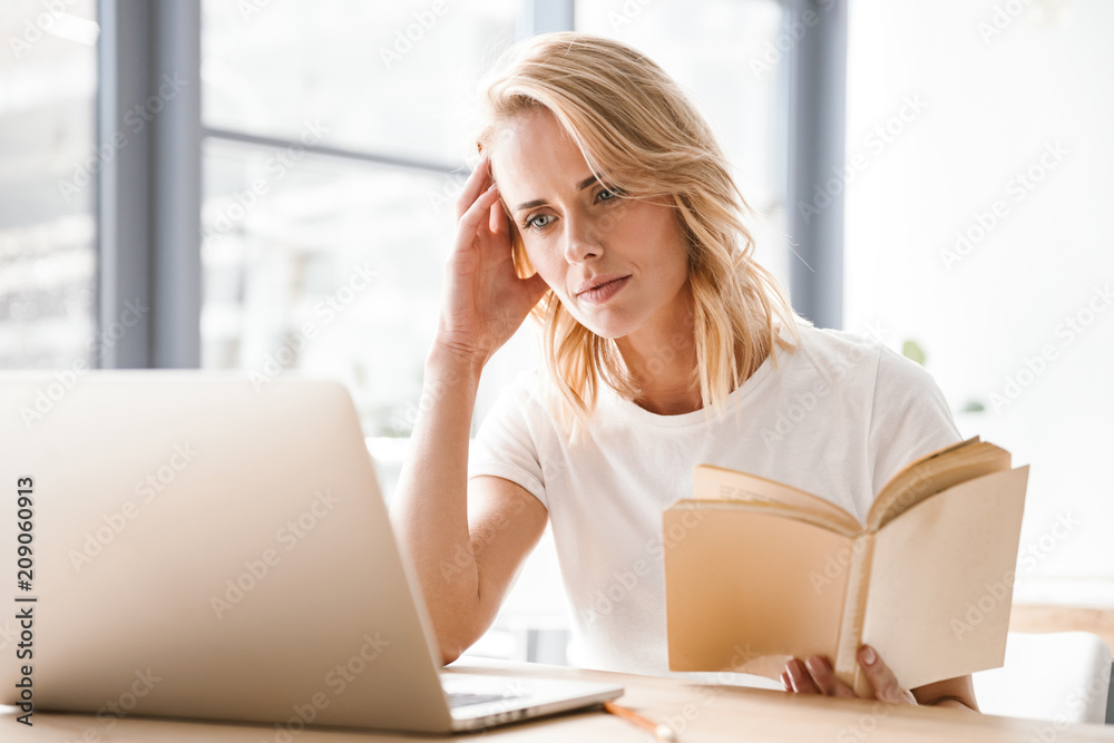 Pensive businesswoman working on laptop computer Pensive businesswoman working on laptop computer