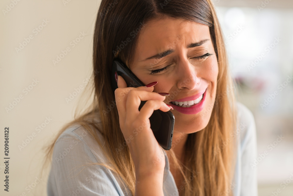 Sad woman talking on the smartphone, depressed and crying. Breaking off Sad woman talking on the smartphone, depressed and crying. Breaking off