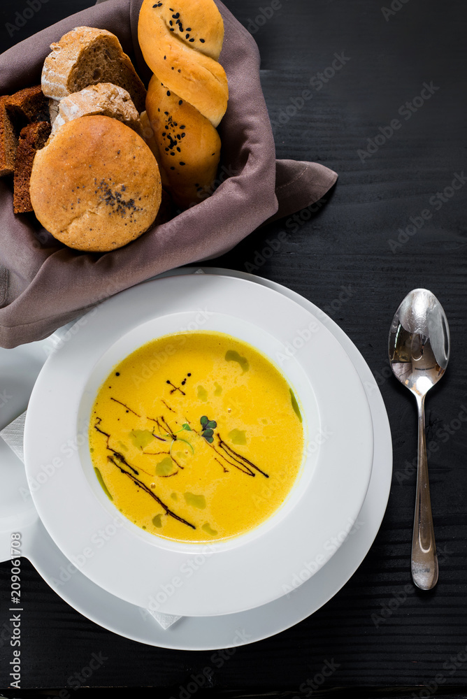 Pumpkin cream soup on wooden background. Top view Pumpkin cream soup on wooden background. Top view