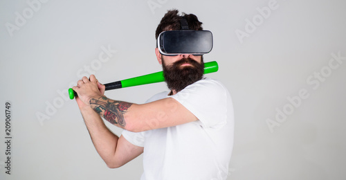 Photography Man in VR glasses with hipster beard and tattoo posing with baseball bat isolated on gray background