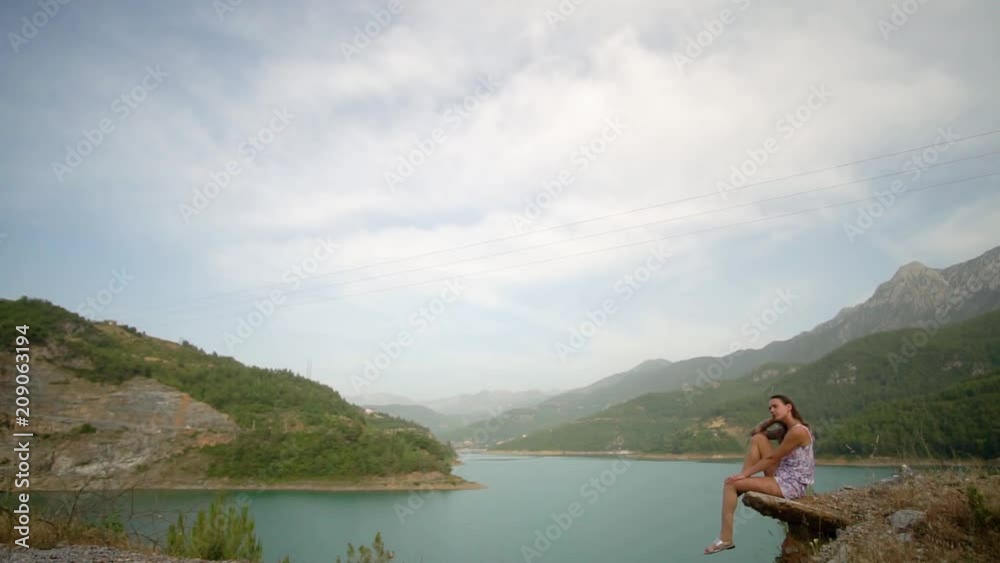Panoramic view of the bay in Alanya, where the girl sits on a rock Panoramic view of the bay in Alanya, where the girl sits on a rock
