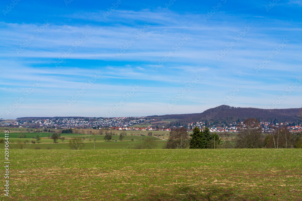 Fototapeta premium View over the fields to a village in Germany