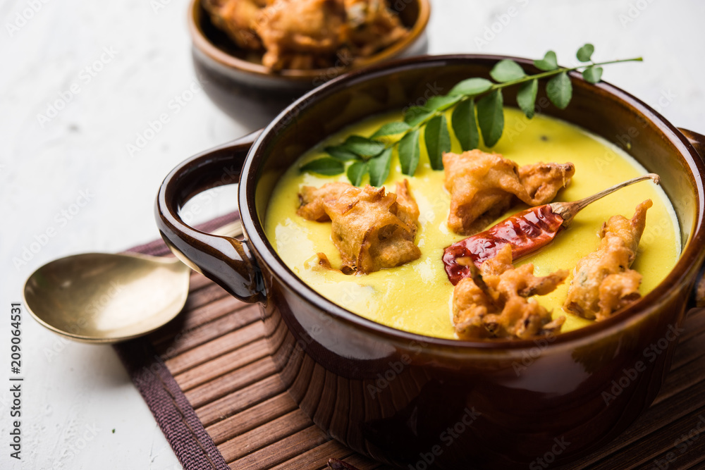 Punjabi Kadhi Pakoda or curry Pakora, Indian cuisine served in a bowl or karahi, selective focus Punjabi Kadhi Pakoda or curry Pakora, Indian cuisine served in a bowl or karahi, selective focus