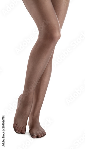 Legs of beautiful young woman in tights on white background