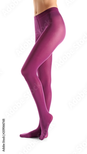 Legs of beautiful young woman in tights on white background