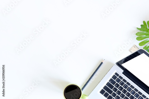 Office desk workspace laptop computer, ruler, pencil and coffee cup top view on white table.