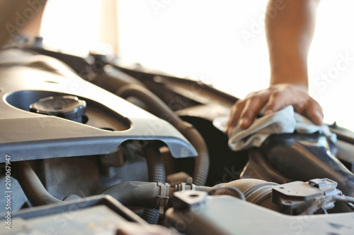 Auto mechanic repairing car in service center, closeup © Pixel-Shot