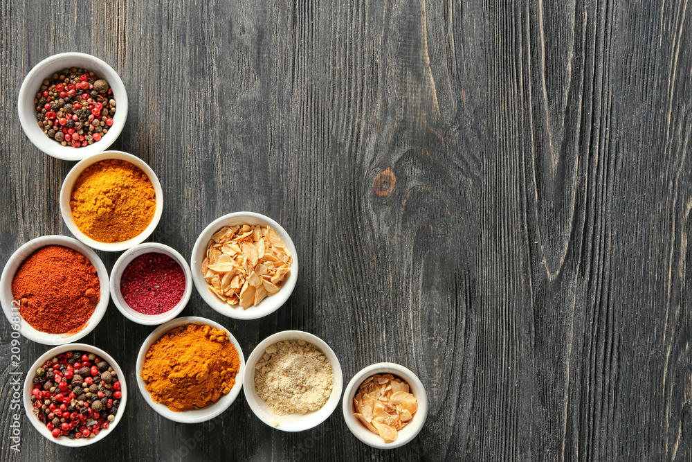 Bowls with various spices on wooden background Bowls with various spices on wooden background