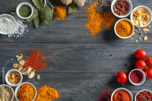 Fototapeta Naklejka Na Ścianę i Meble -  Frame made of various spices on wooden table