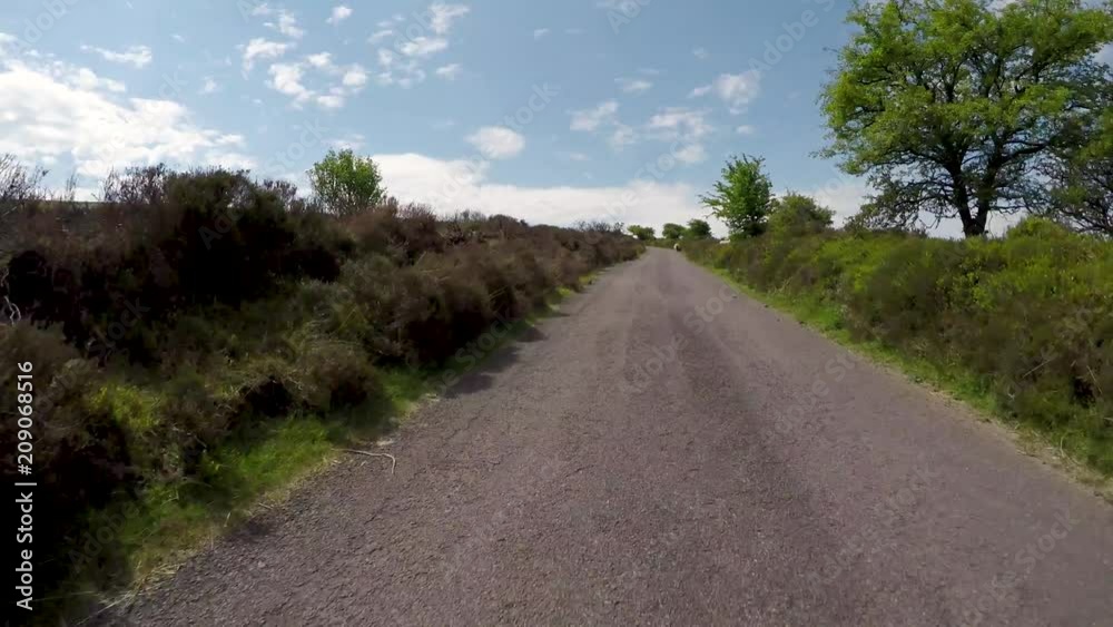 POV driving through Dunkery Beacon hill on Exmoor National Park in Somerset England with sheep at the side of the road POV driving through Dunkery Beacon hill on Exmoor National Park in Somerset England with sheep at the side of the road