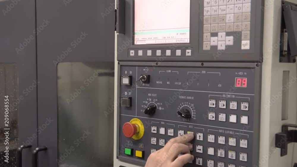 Close up. Man turns on the machine to process the Computer-controlled ...