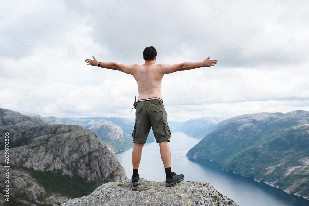 Man Standing on Top of Pulpit Rock in Norway