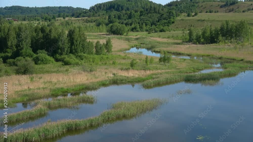 View of Gorodishchenskoye lake on a Sunny June day. Izborsk, Russia View of Gorodishchenskoye lake on a Sunny June day. Izborsk, Russia
