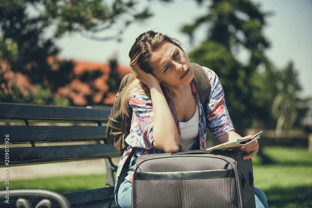 Young woman is going on vacation. She is waiting for her transportation. Young woman is going on vacation. She is waiting for her transportation.