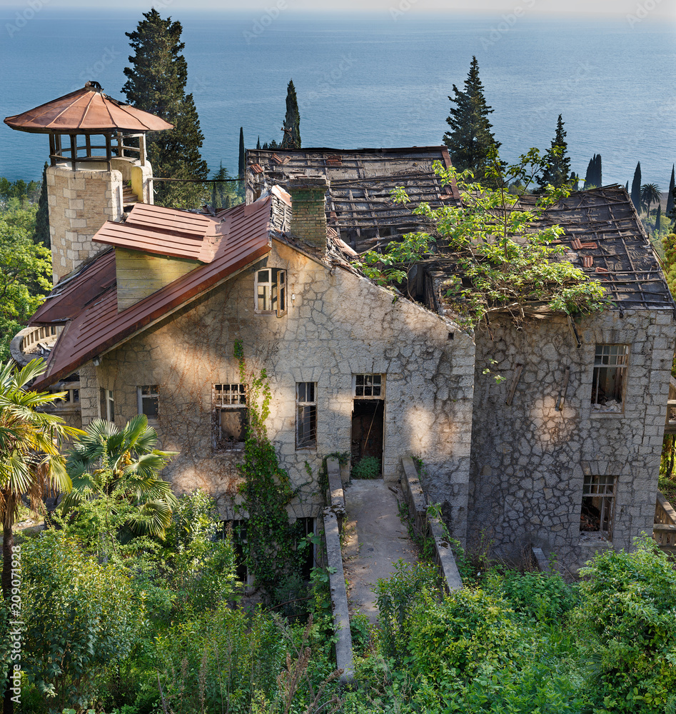 Abandon rusty house on the sea, interesting place of Abkhazia, old gagra. panorama view Abandon rusty house on the sea, interesting place of Abkhazia, old gagra. panorama view