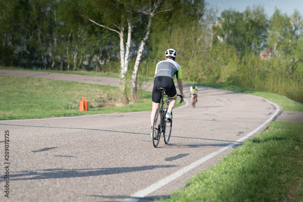 triathlete cycling on a bicycle at the training road in Moscow