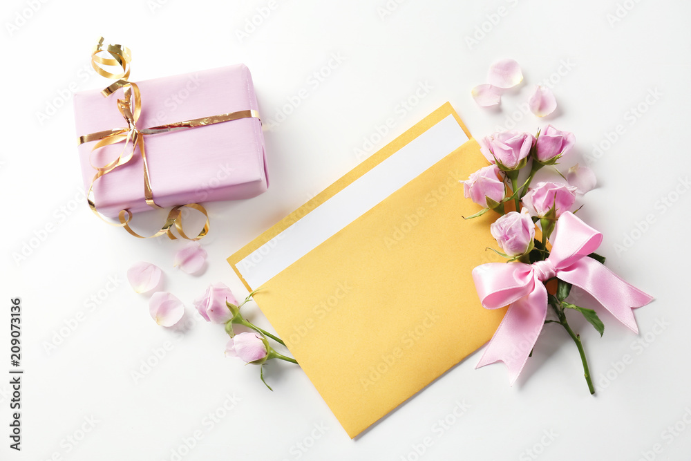 Open mail envelope with flowers and gift box on white background Open mail envelope with flowers and gift box on white background