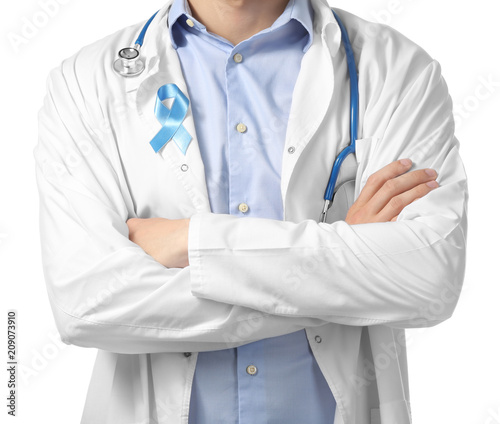 Doctor with symbolic blue ribbon on white background. Prostate cancer concept