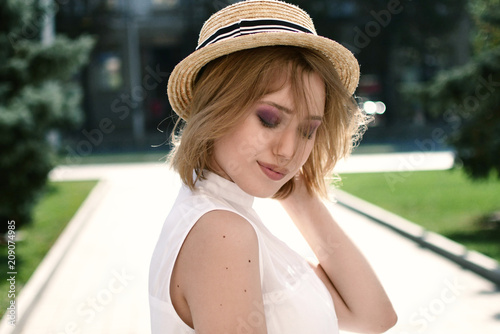 Portrait of smiling woman in sunhat looking at camera