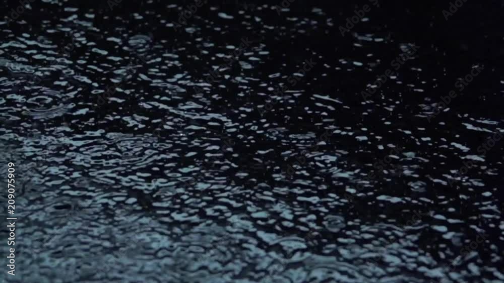Water rain drops on Black Background. Slow motion. Macro. Water rain drops on Black Background. Slow motion. Macro.