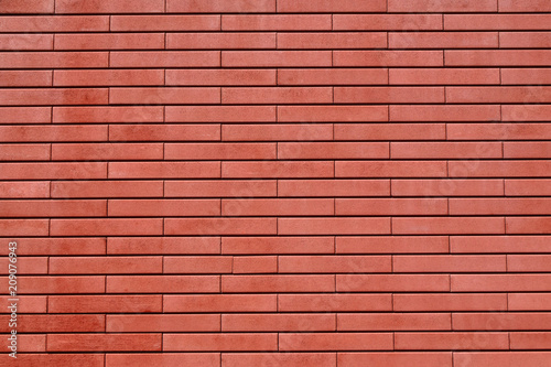 Red brick texture wall or facade as abstract colorful background.