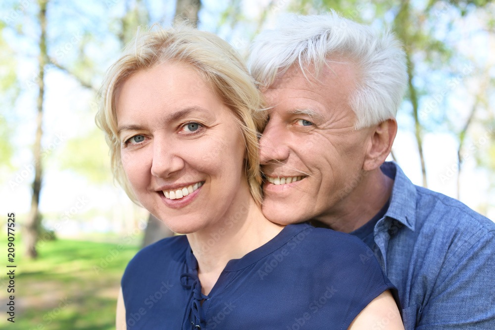 Mature couple resting in park on spring day