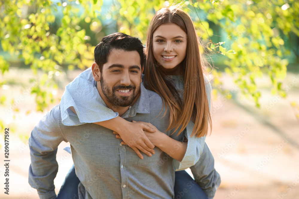 Fototapeta premium Happy young couple in park on spring day