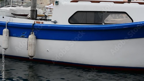 A small motor boat moored at the port.