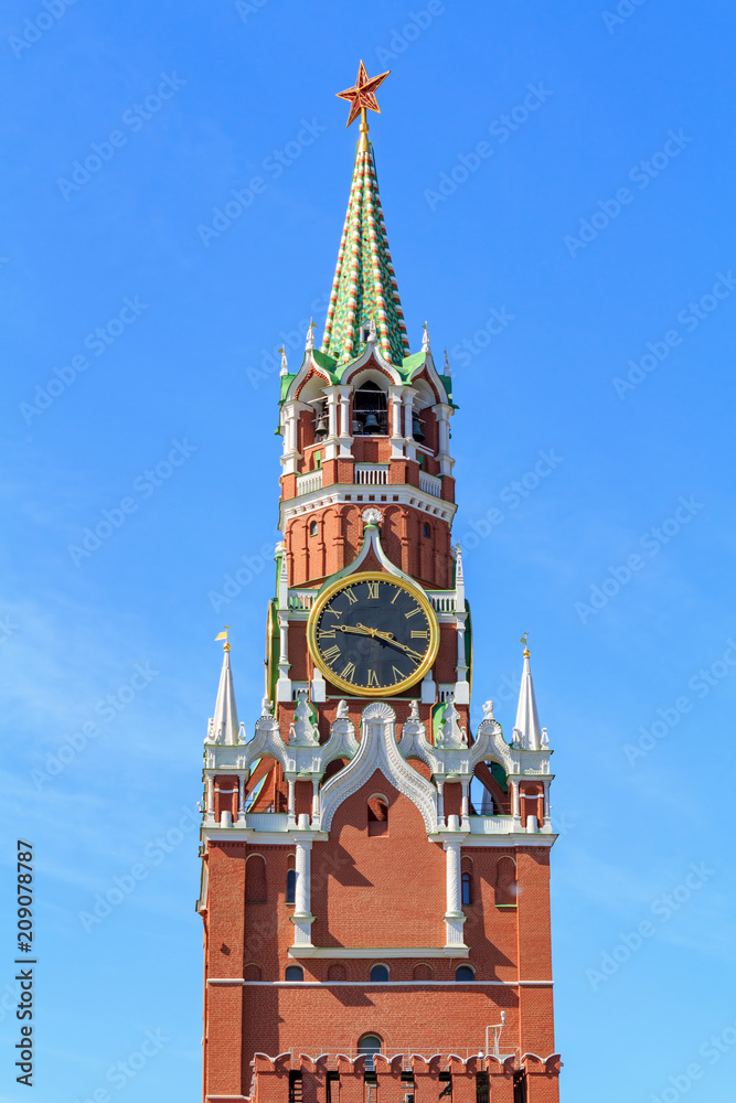 Spasskaya tower of Moscow Kremlin against blue sky on a sunny summer morning