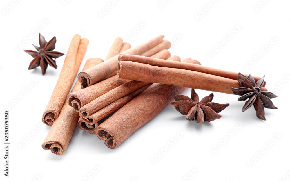Aromatic cinnamon sticks and anise stars on white background Aromatic cinnamon sticks and anise stars on white background