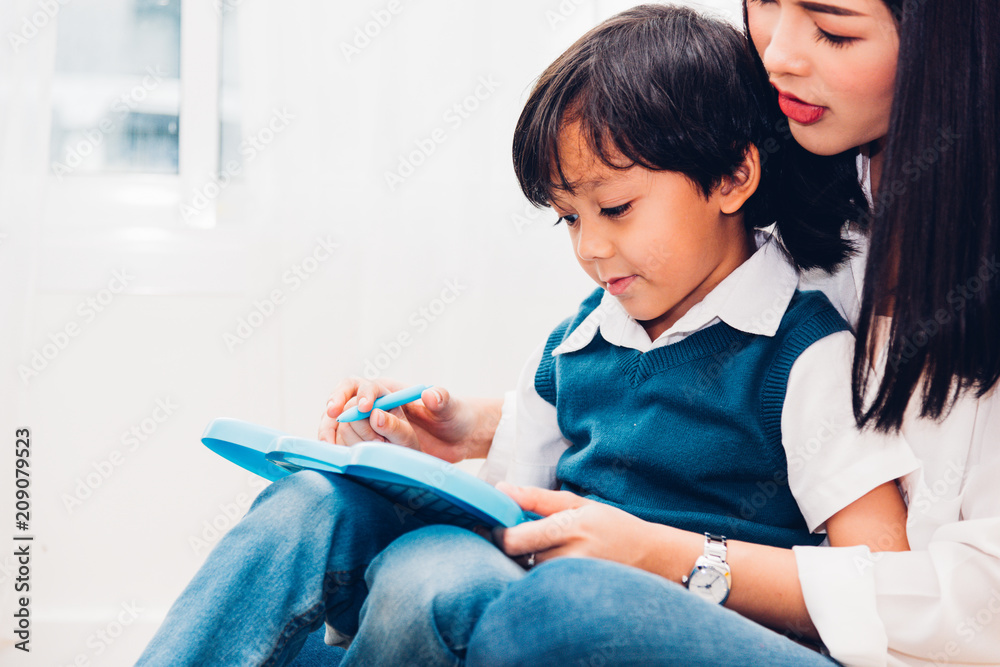 Child kid boy kindergarten and beautiful mother drawing together Child kid boy kindergarten and beautiful mother drawing together