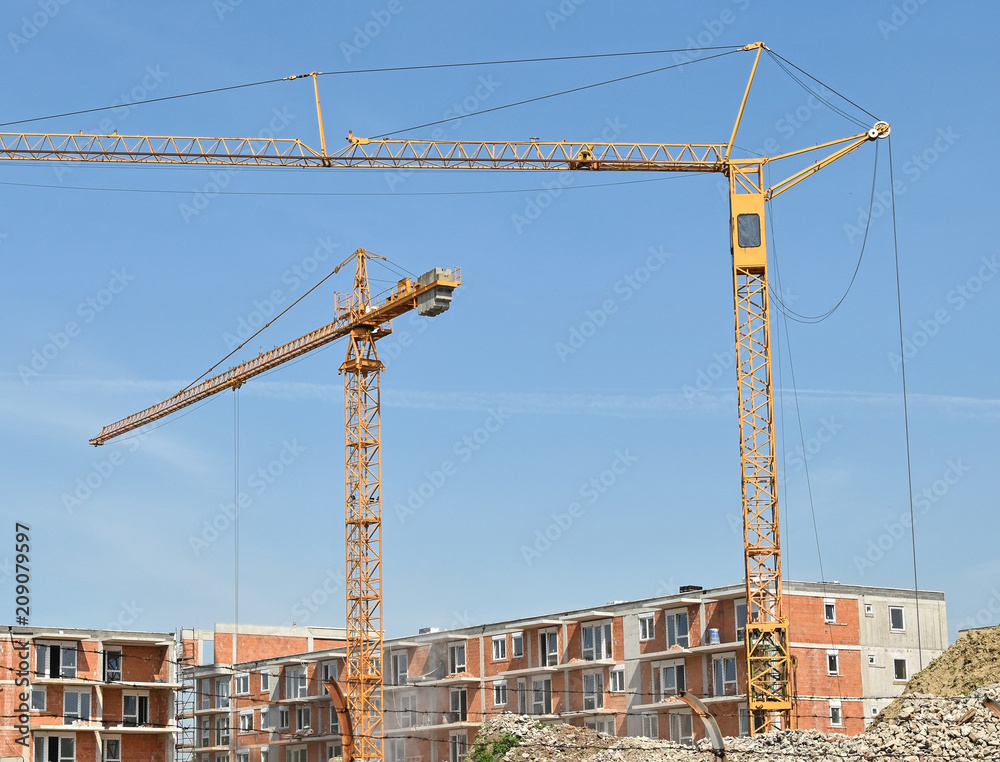 Tower cranes works at the construction site