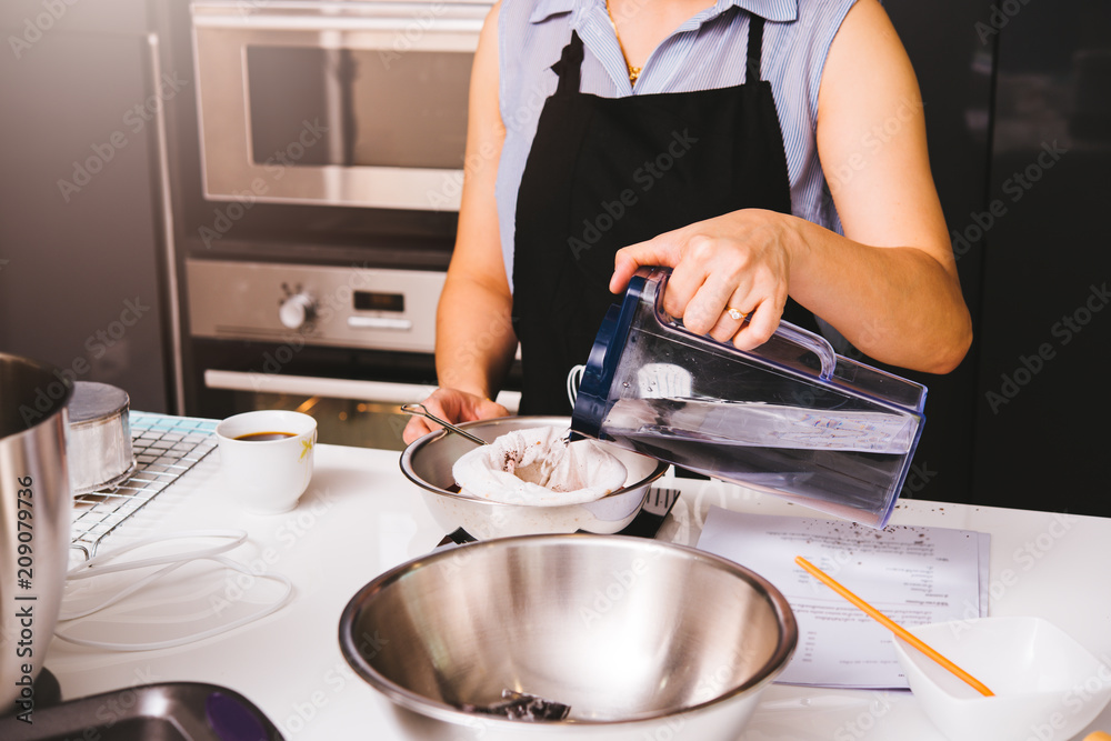 Woman girl in kitchen cooking thai tea Woman girl in kitchen cooking thai tea