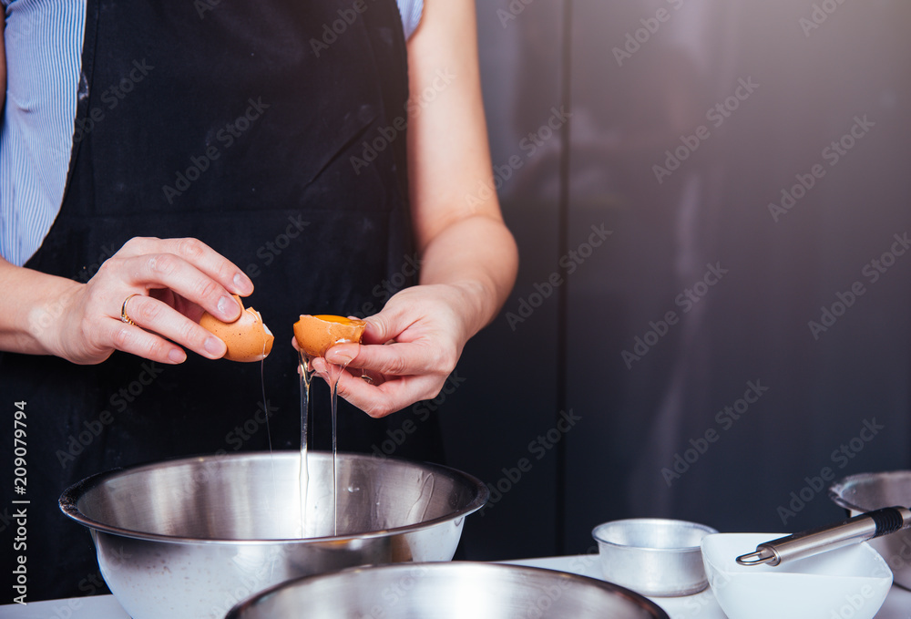 Woman girl baker in kitchen cooking whisk egg to bowl Woman girl baker in kitchen cooking whisk egg to bowl
