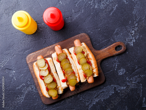 Picture on top of buns with sausages on cutting board photo