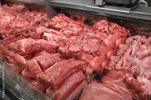 Refrigerated display case with fresh meat in butcher shop