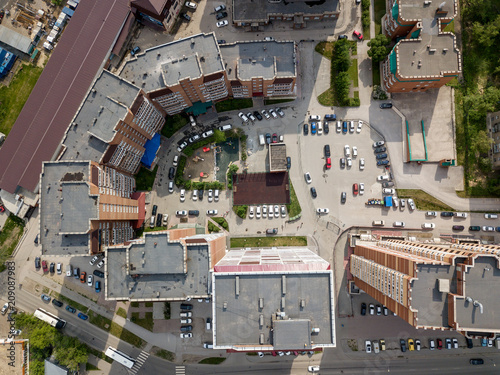 Aerial view of new buildings in semicircle shape in the city with a lot of cars. Russian streets, Novosibirsk.