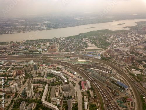 Aerial view of old and new russian buildings with rails and river in the city with a lot of cars. Russian streets, Novosibirsk.