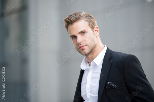 Businessman on the go. Guy handsome attractive office worker go meeting. Man well groomed elegant formal suit walks urban background. Businessman serious quick walk during lunch time