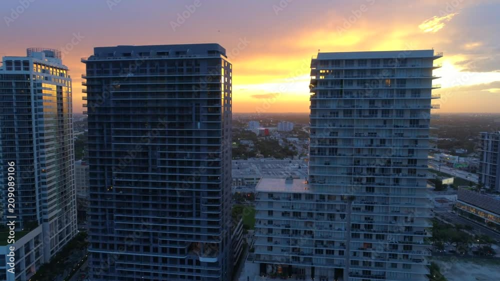 Aerial drone reveal video sunset behind buildings motion 4k