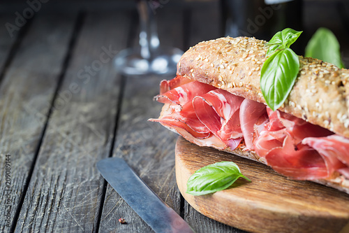 Sandwich with jamon serrano and basil