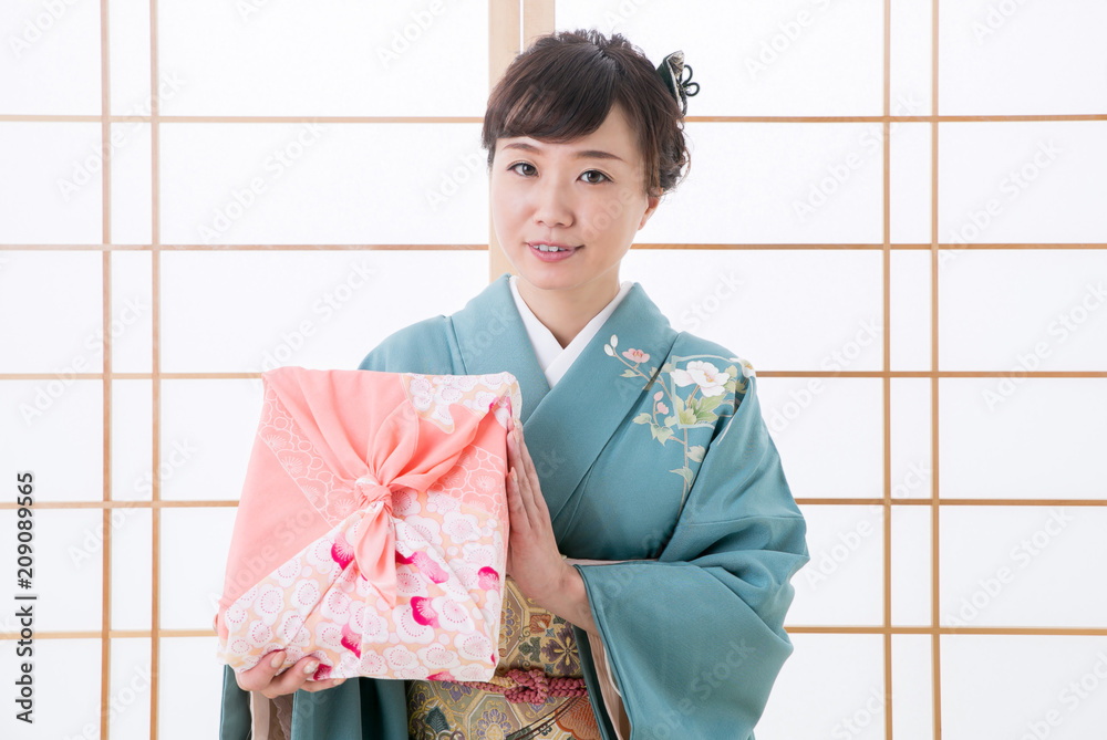 引き出物と着物姿の女性(笑顔)
引き出物と着物姿の女性(笑顔)