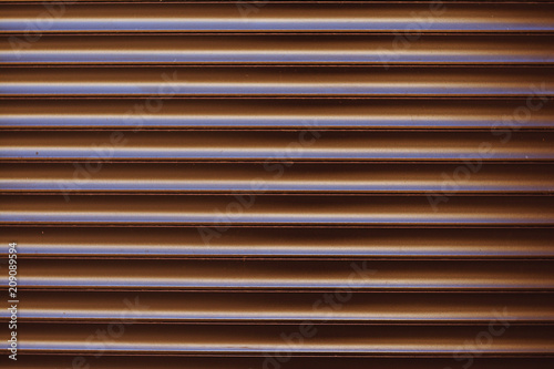 Surface textured horizontal, striped, brown facing wall, siding.