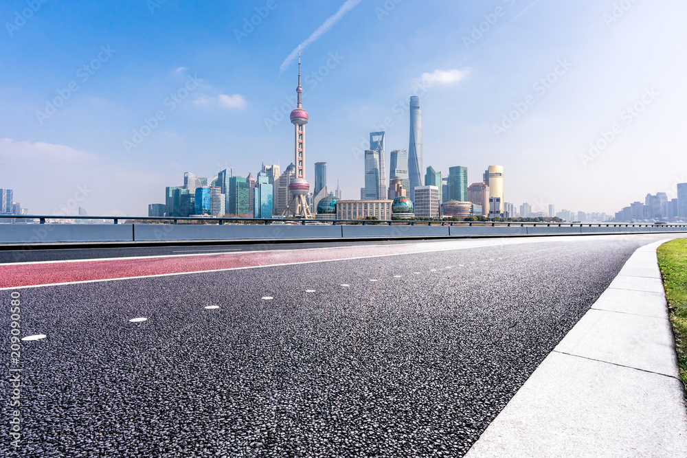 empty asphalt road with modern office building empty asphalt road with modern office building
