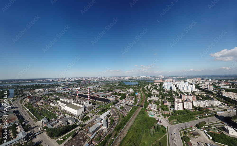 Aerial view of old and new russian buildings with lake and blue sky in the city with a lot of cars and plant. Russian streets, Novosibirsk.