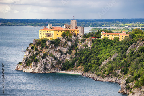 Fototapeta Naklejka Na Ścianę i Meble -  View of Duino castle from the Rilke trail, a tourist trail, providing a scenic view of Trieste gulf. Friuli Venezia Giulia, Italy.
