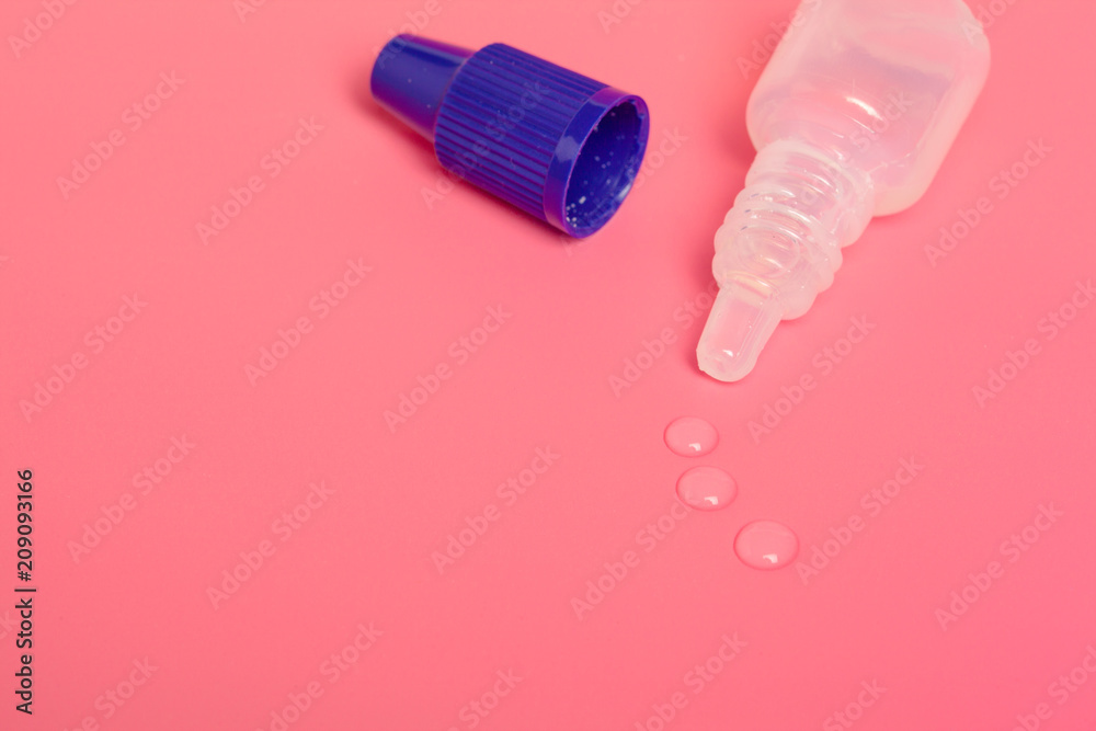 Eye drops isolated on pink background Eye drops isolated on pink background