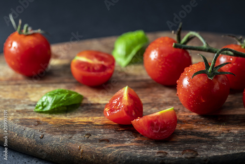 Tomatoes on the vine on wooden board
