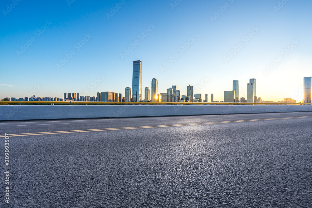 empty asphalt road with modern office building empty asphalt road with modern office building