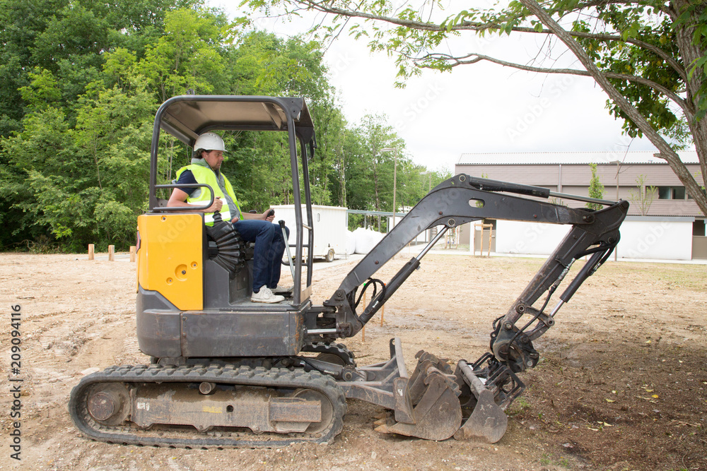 Picture of working excavator driver man in summer day Picture of working excavator driver man in summer day